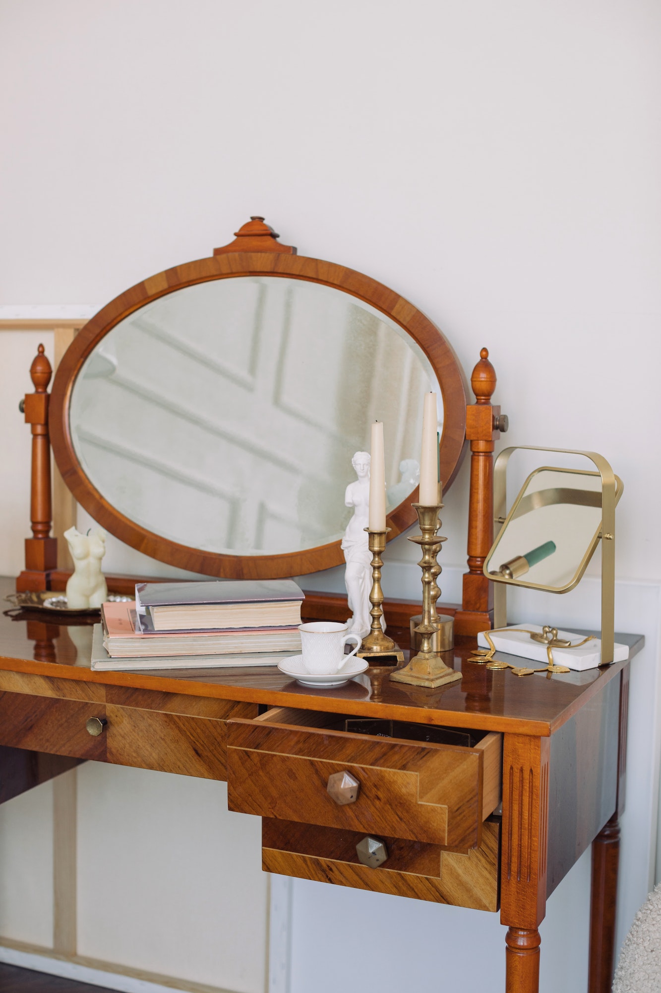 stack-of-books-candlesticks-cup-of-coffee-on-vintage-dressing-table-with-mirror-.jpg