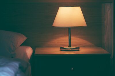 Vintage lamp on night table in hotel room